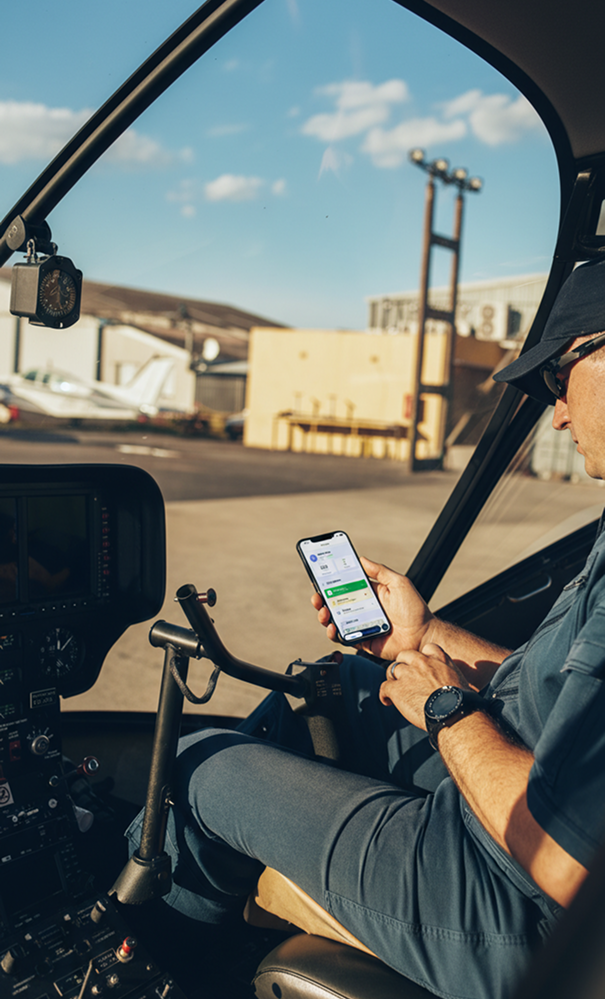 Aircraft owner checking FlightApp in a helicopter cockpit